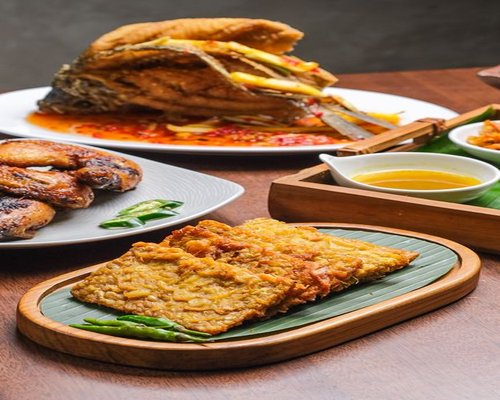 Traditional Indonesian vegetables and tempeh displayed on a wooden table