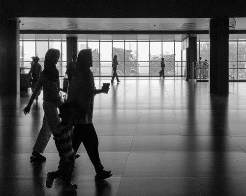 Commuters walking near a park in Jakarta early morning