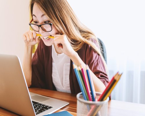 Person doing light stretching near an office desk